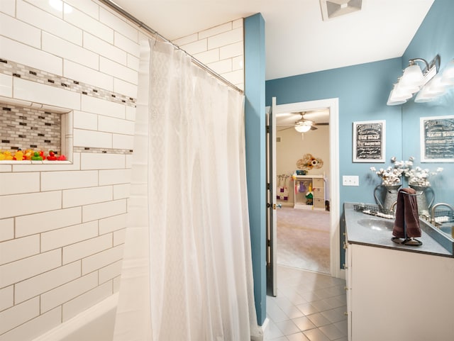 bathroom featuring tile patterned floors, ceiling fan, shower / bath combo with shower curtain, and vanity