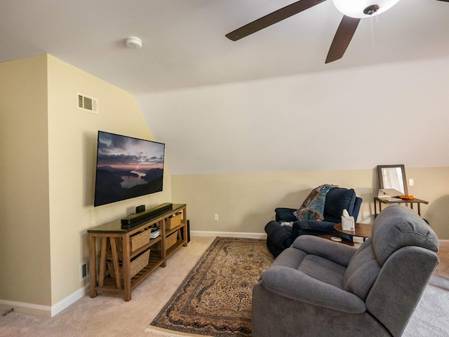 carpeted living room featuring ceiling fan and lofted ceiling