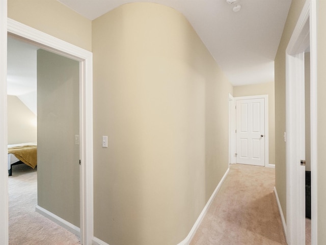 hallway featuring light carpet