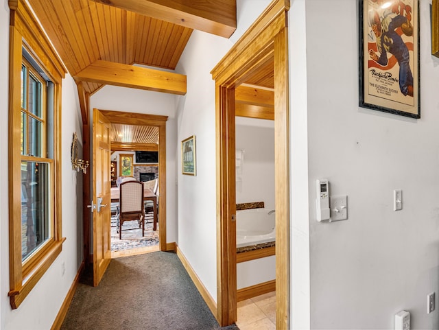 hall featuring wooden ceiling, beamed ceiling, and light carpet