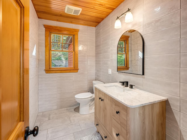 bathroom with vanity, tile walls, toilet, and wood ceiling