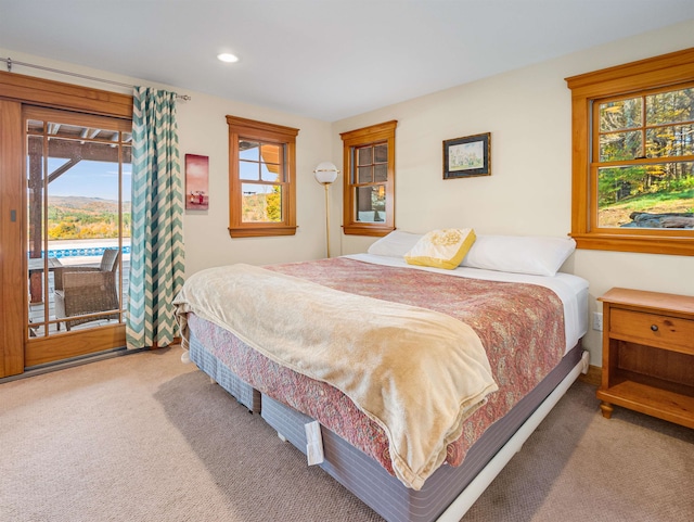 bedroom with carpet flooring and access to exterior