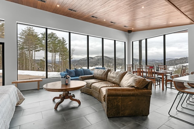 tiled living room with wooden ceiling and a mountain view