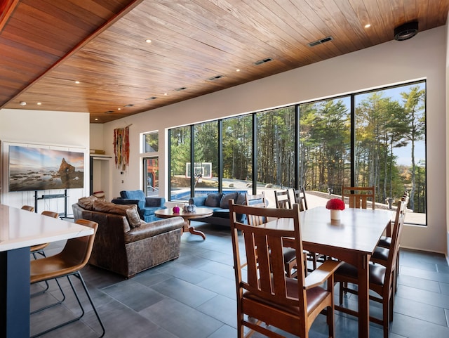 tiled dining room featuring wooden ceiling