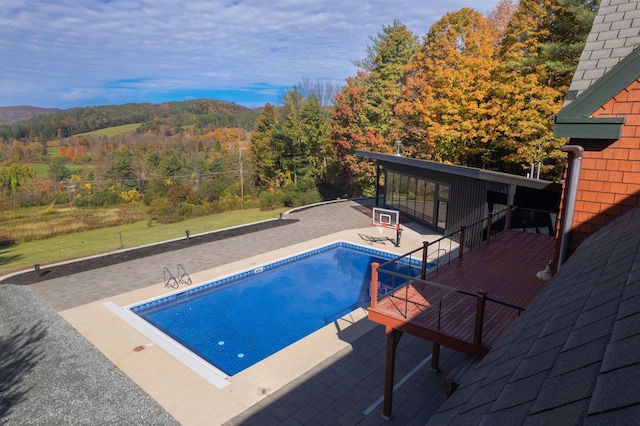 view of swimming pool featuring a mountain view and a patio area