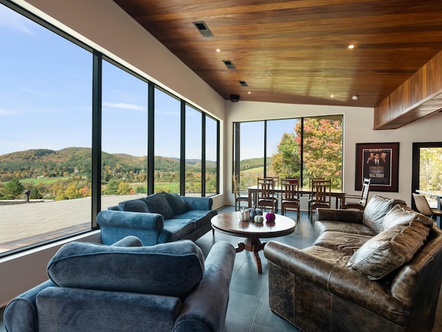 sunroom featuring a mountain view, wood ceiling, and vaulted ceiling