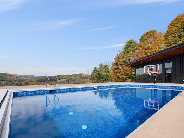 view of swimming pool with a mountain view