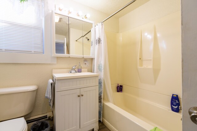 full bathroom featuring vanity, toilet, a textured ceiling, and shower / tub combo with curtain