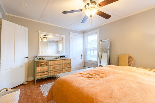 bedroom featuring crown molding, ceiling fan, and hardwood / wood-style floors