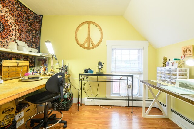 home office with vaulted ceiling and light hardwood / wood-style floors