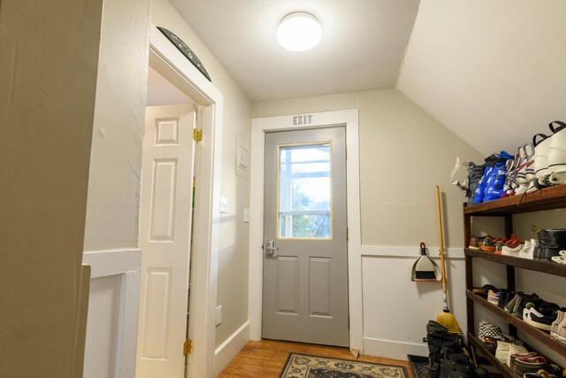 entryway with lofted ceiling and light hardwood / wood-style flooring