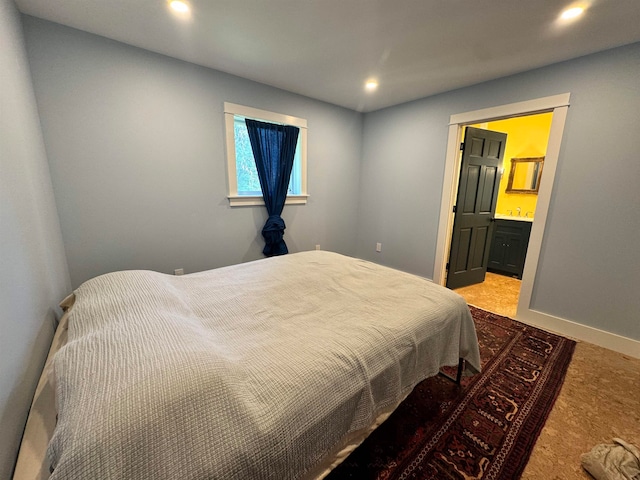 carpeted bedroom featuring ensuite bathroom