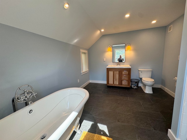 bathroom featuring lofted ceiling, a tub to relax in, vanity, and toilet