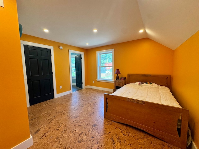 carpeted bedroom featuring lofted ceiling