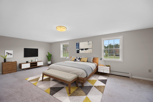 bedroom featuring light colored carpet, multiple windows, and a baseboard radiator