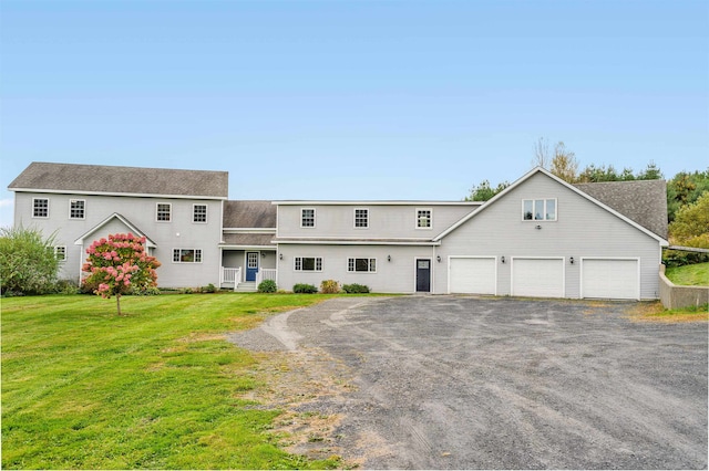 view of front of property with a front yard and a garage