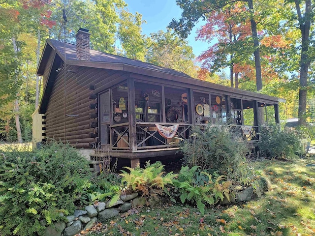 back of house with a sunroom