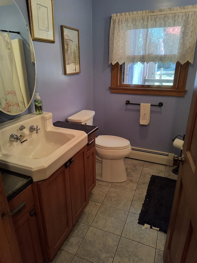 bathroom featuring vanity, a baseboard radiator, toilet, and tile patterned floors