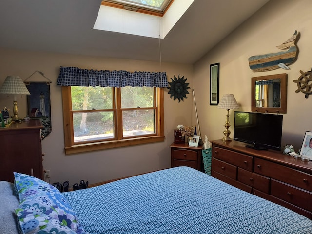 bedroom with lofted ceiling with skylight