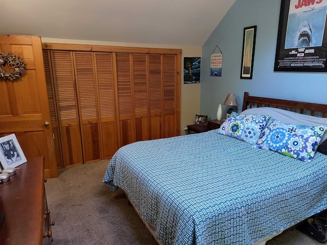 bedroom with carpet floors, a closet, and vaulted ceiling