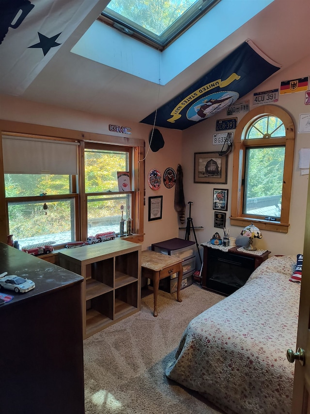 carpeted bedroom with lofted ceiling with skylight