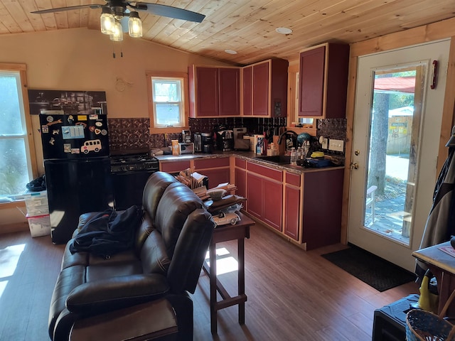 kitchen with light wood-type flooring, black appliances, wooden ceiling, sink, and vaulted ceiling