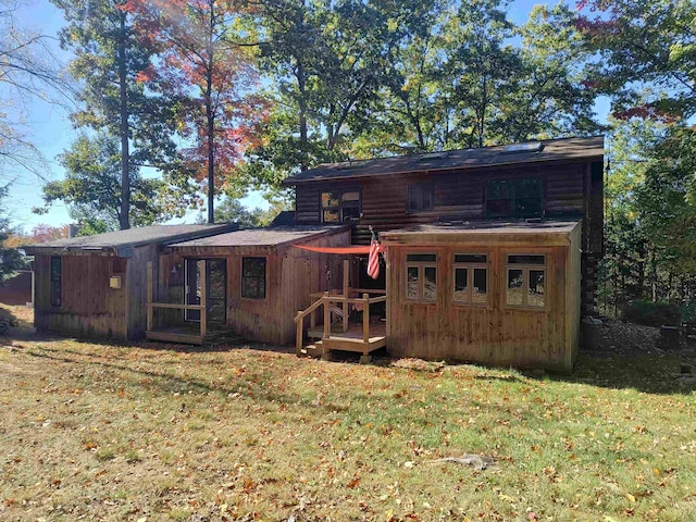 rear view of house with a lawn