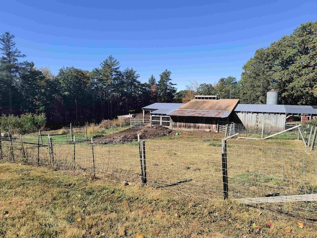 view of yard with an outdoor structure and a rural view