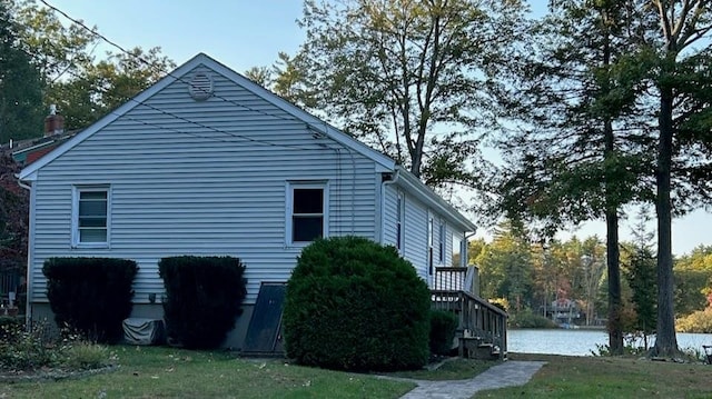 view of side of home with a yard