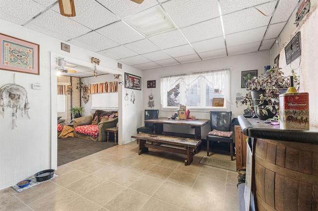 miscellaneous room featuring ceiling fan, tile patterned floors, and a paneled ceiling