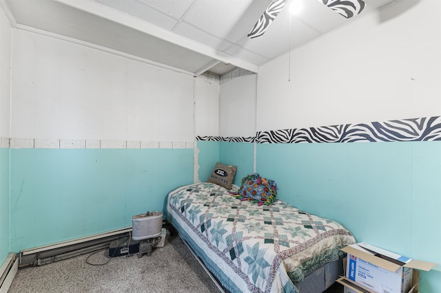 carpeted bedroom featuring a baseboard heating unit