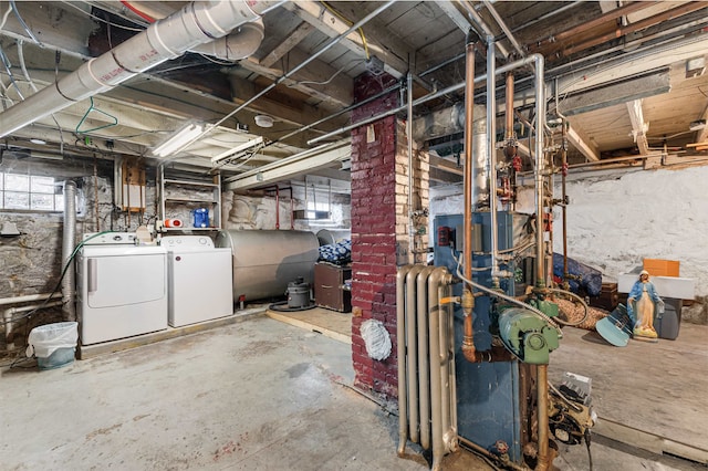 basement with washer and dryer, plenty of natural light, and radiator