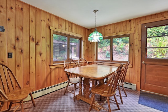 dining area with wooden walls and baseboard heating