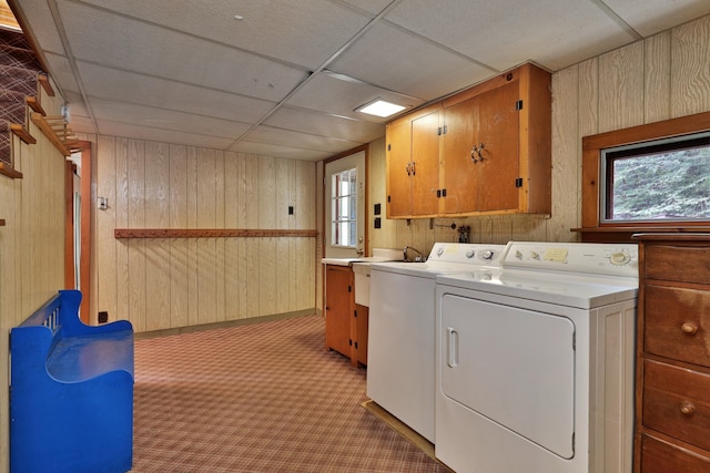 washroom featuring washer and clothes dryer, light colored carpet, cabinets, and a healthy amount of sunlight