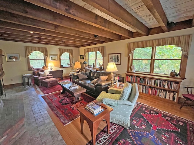 living room with hardwood / wood-style flooring, beamed ceiling, and a wealth of natural light