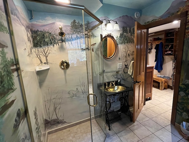 bathroom with a shower with door, tile patterned floors, and vanity