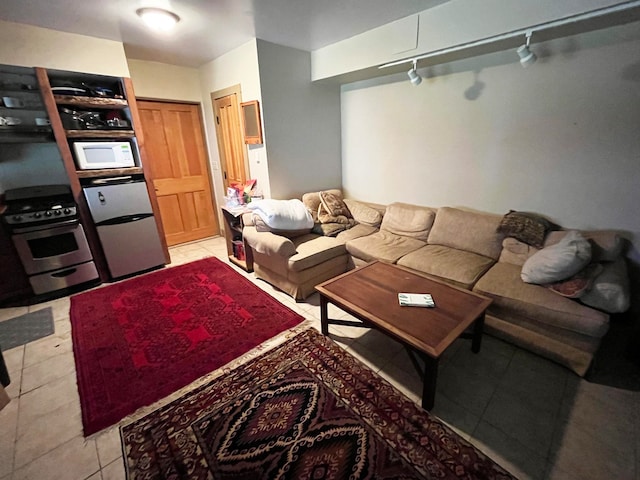 living room with rail lighting and light tile patterned floors