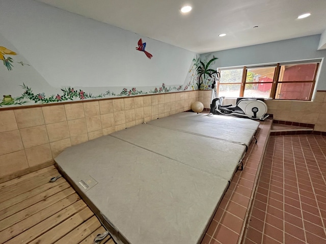 interior space with tile patterned flooring and tile walls