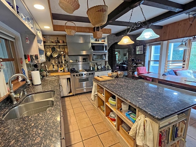 kitchen featuring sink, a kitchen island, decorative light fixtures, exhaust hood, and appliances with stainless steel finishes