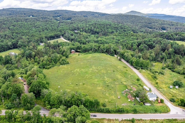 drone / aerial view featuring a mountain view and a wooded view