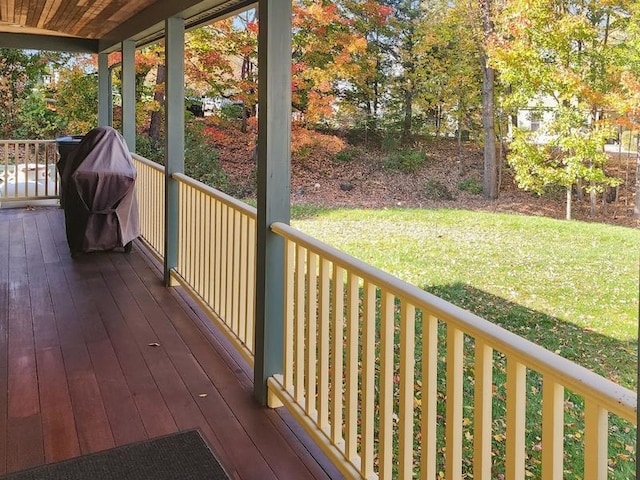 wooden deck featuring a yard