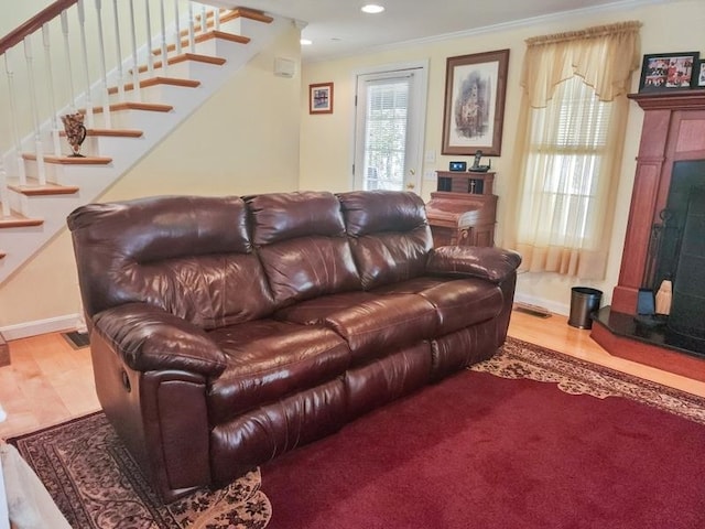 living room featuring crown molding and light wood-type flooring