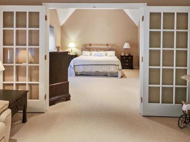 bedroom featuring vaulted ceiling and carpet