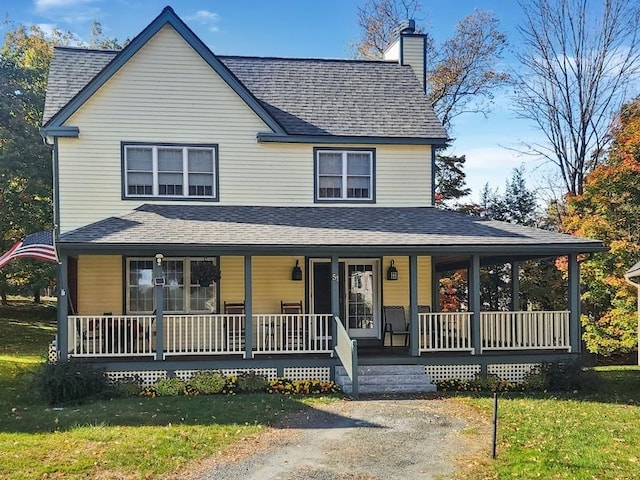 farmhouse featuring a porch and a front lawn