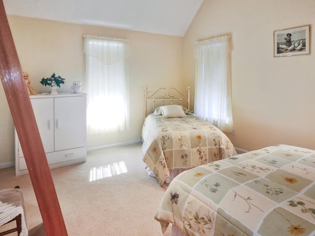 carpeted bedroom featuring vaulted ceiling