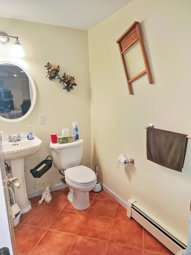 bathroom with tile patterned flooring, sink, a baseboard heating unit, and toilet