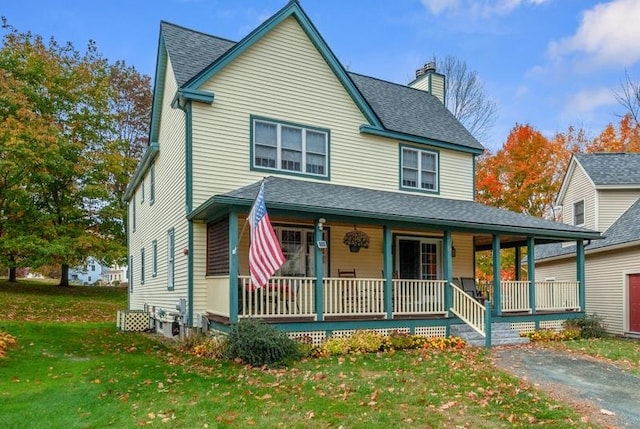 view of front of home with a front lawn and covered porch