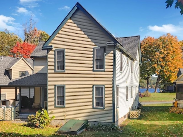 rear view of house featuring a lawn