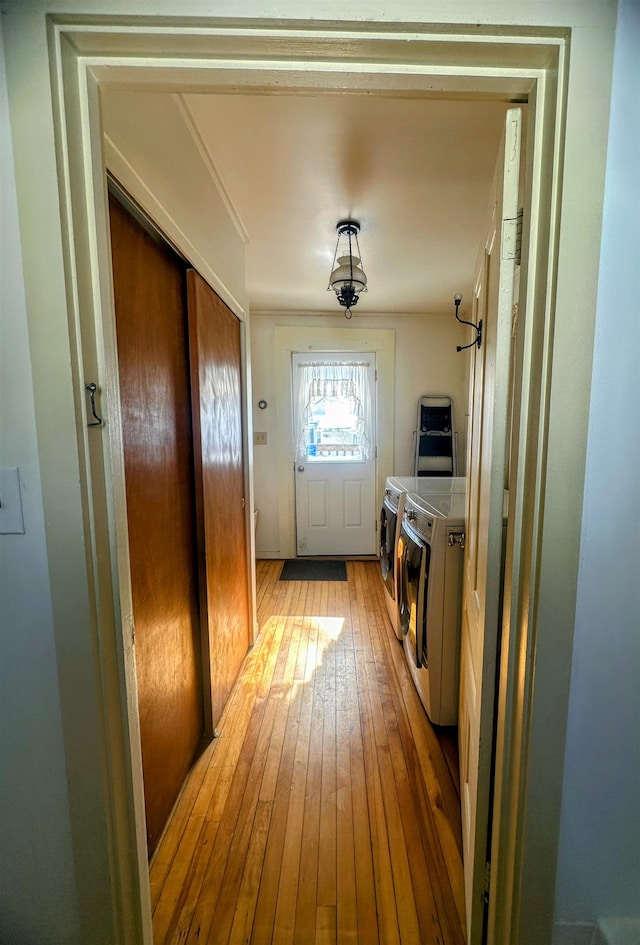 entryway featuring stairway, wallpapered walls, and light wood finished floors