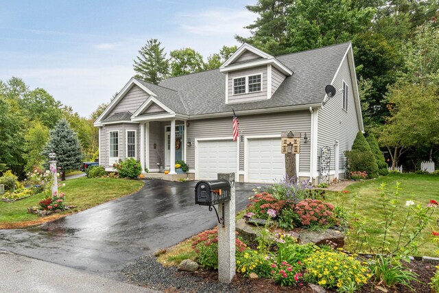 view of front of home with a front yard and a garage